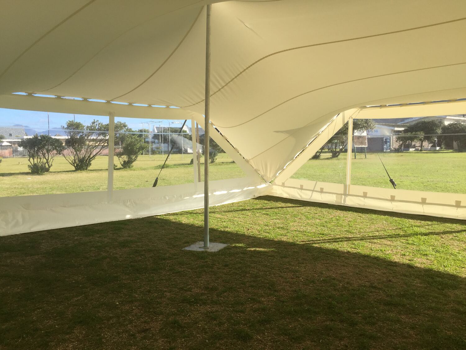 Inside a stretch tent closed in with clear window side walls